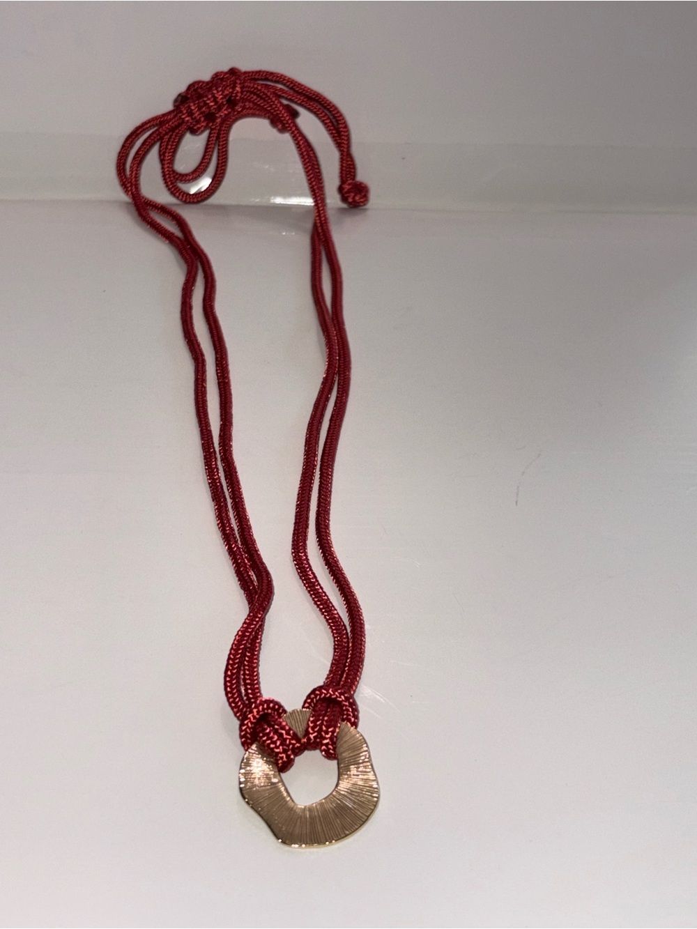 Plunder Gold-Tone Pendant on Red Cord Necklace